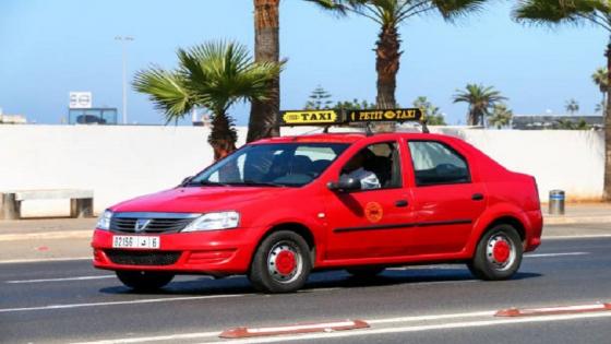 Casablanca, Morocco - September 29, 2019: Red taxi car Dacia Logan in the city street.